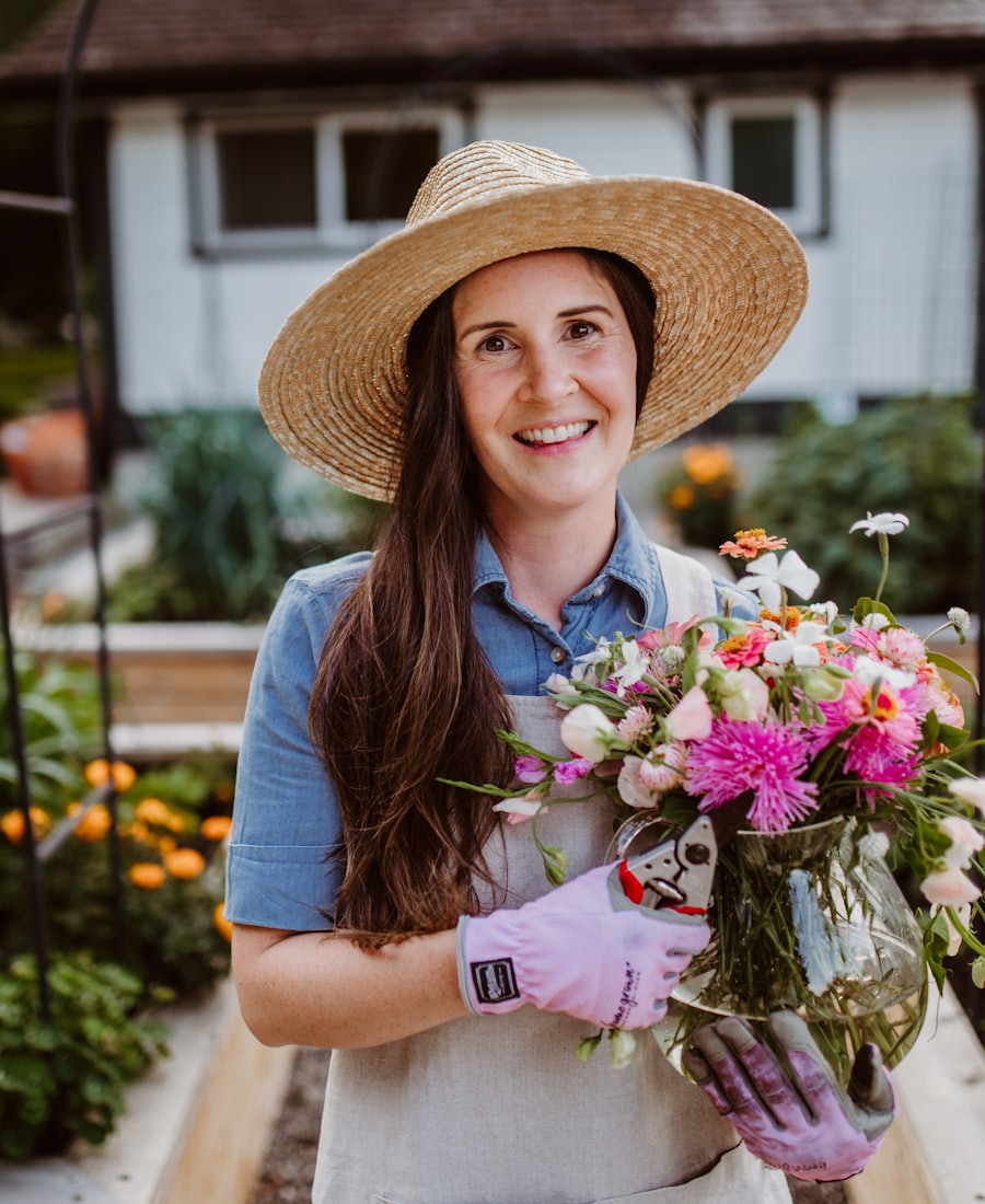 Marnie Ellison, founder of Petal & Press, holding a vase of seasonal flowers