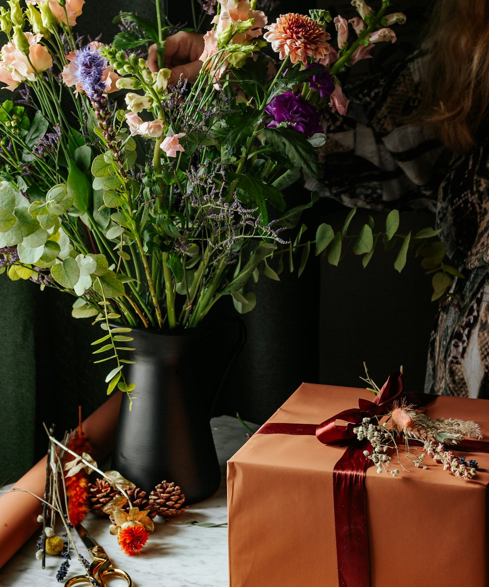 Seasonal flowers being arranged on the Petal & Press bench